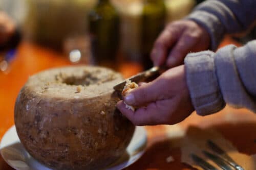 Man Cutting Casu Marzu Cheese