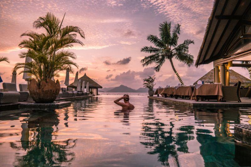 Man in Infinity Pool on a Tropical Vacation in Seychelles