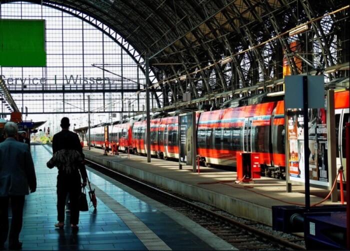 German station with red trains waiting