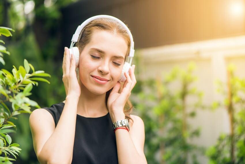 Woman wearing Headphones Listening to Music