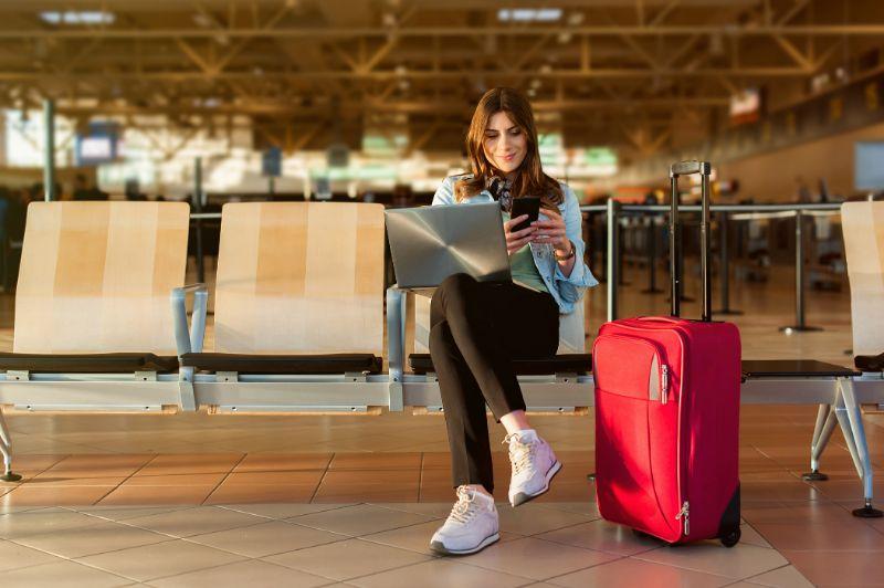 Young Female Traveler in the Airport Terminal Hall