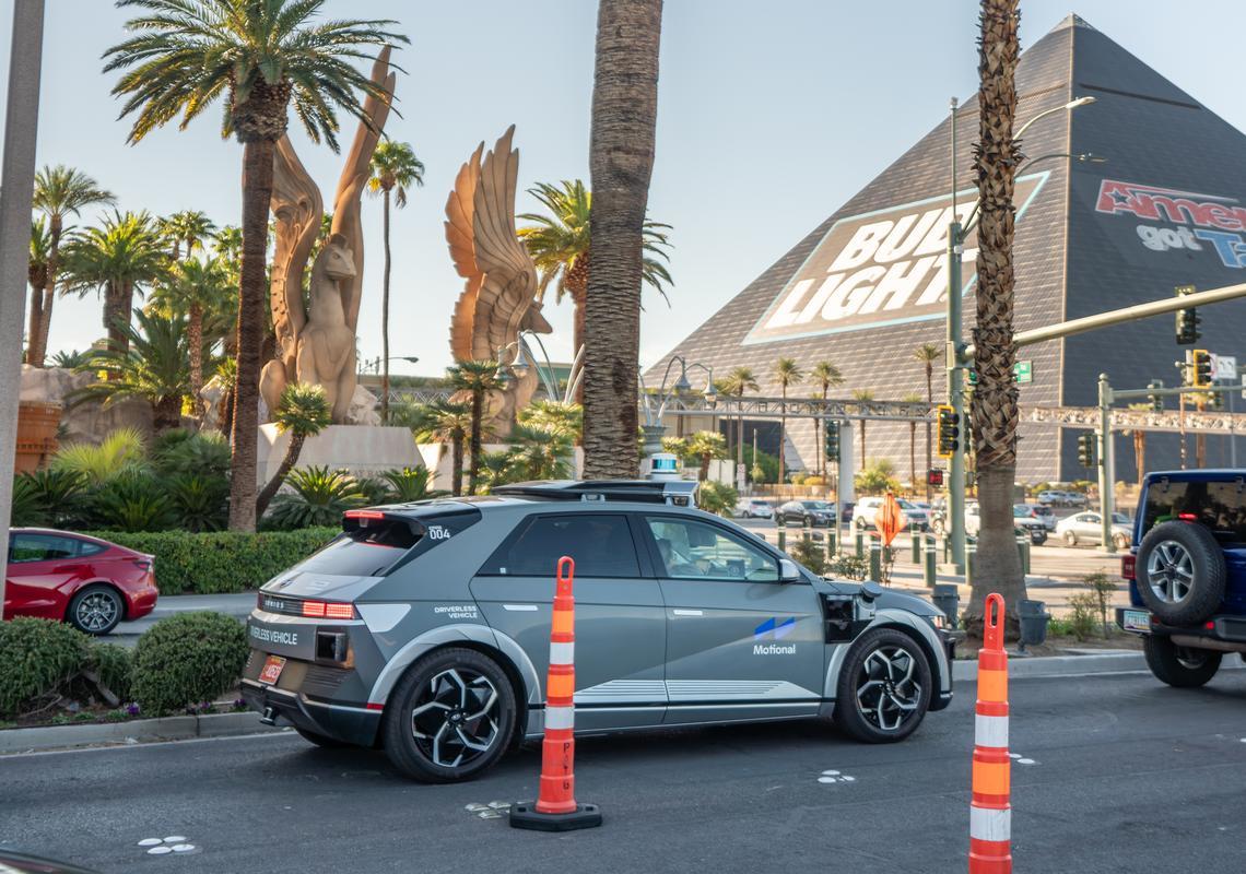 Driverless vehicle near Luxor Hotel in Las Vegas, showcasing autonomous technology amidst iconic landmarks.