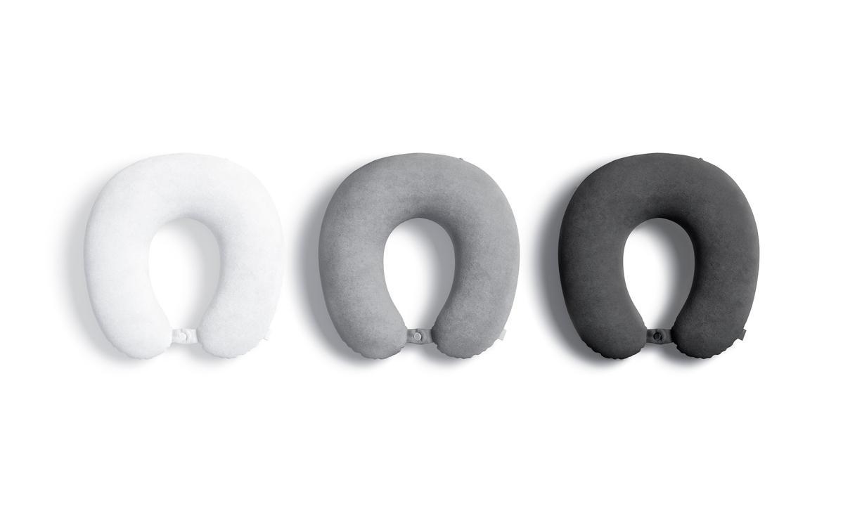 Three travel neck pillows in varying shades of gray, designed for comfort and relief during travel.