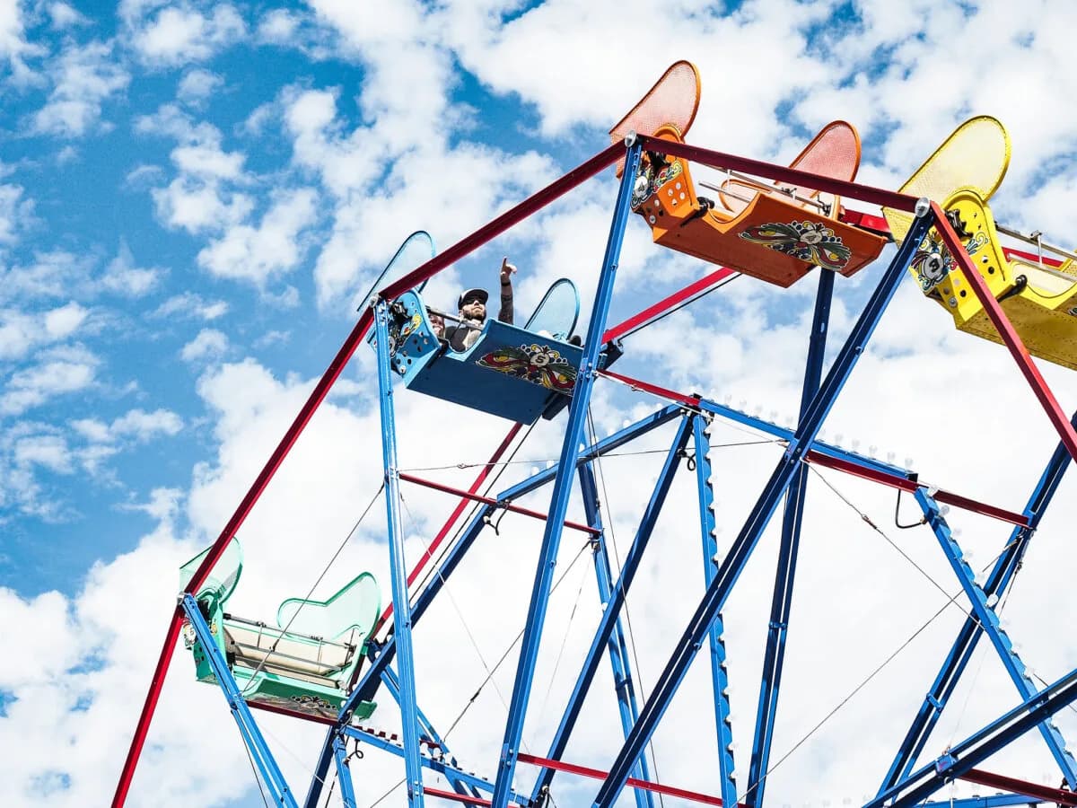 Two riders enjoying the view from the Balboa Fun Zone Ferry Wheel