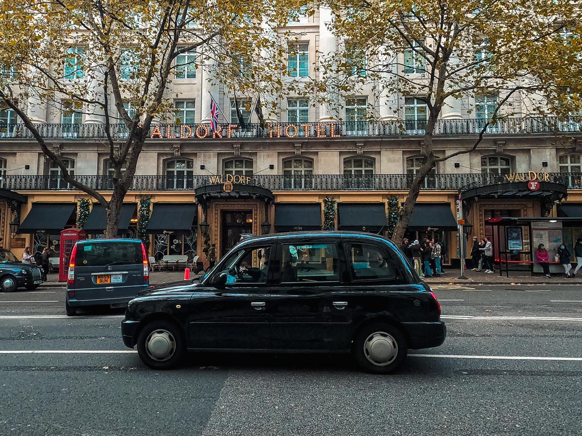 Black cab in front of The Waldorf Hilton Hotel on Aldwych, London, UK