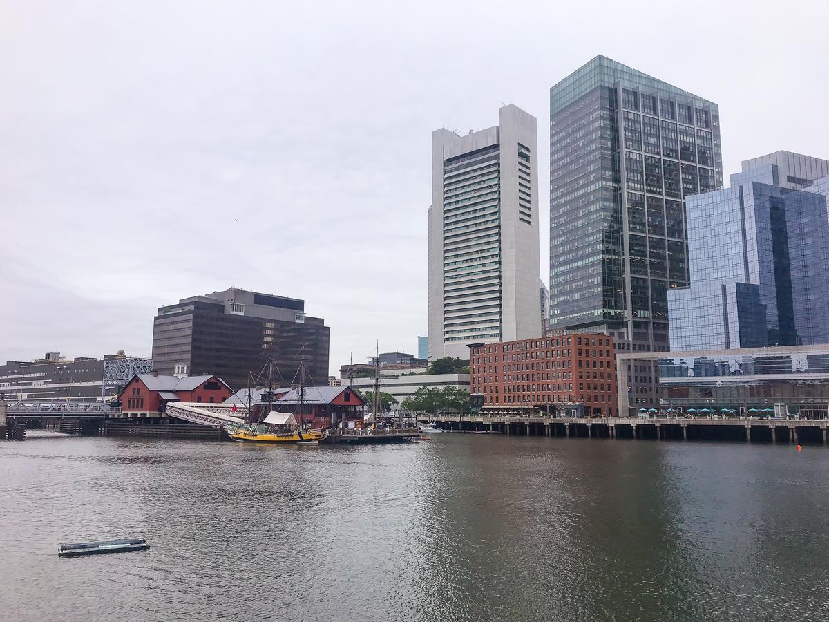 Boston Harbor skyline with historic sailing ship and modern buildings