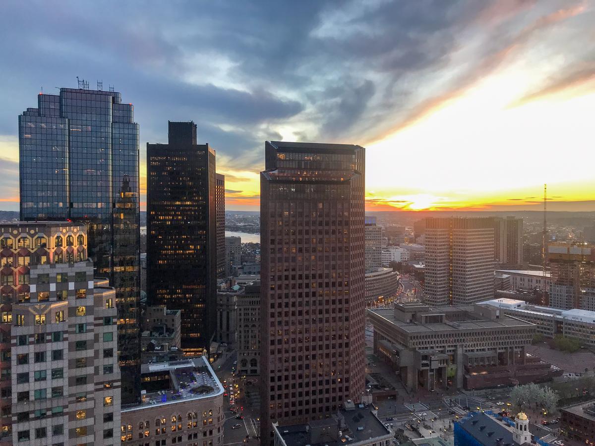 Sunset over Boston skyline with warm hues