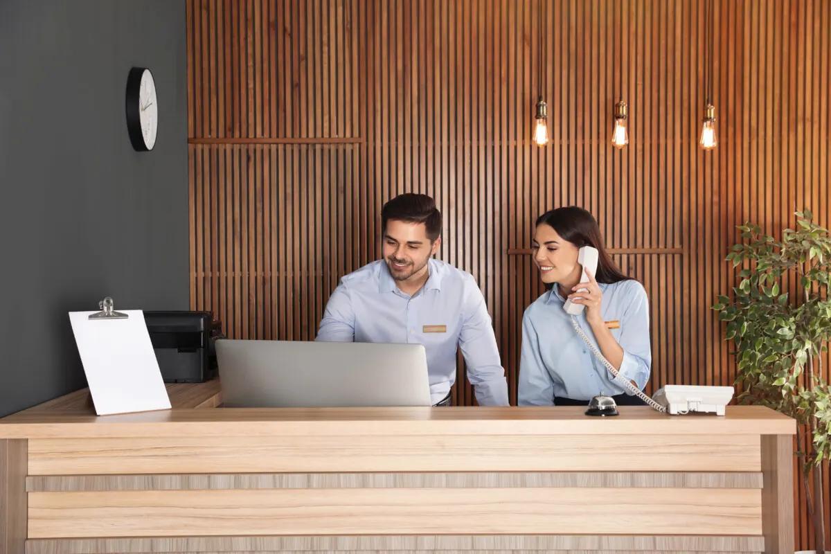 Two workers on a concierge desk