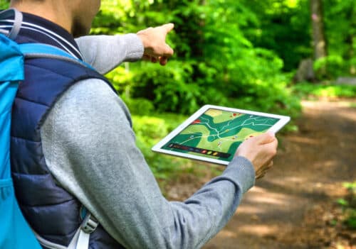 Man hiking with Tablet that has a GPS