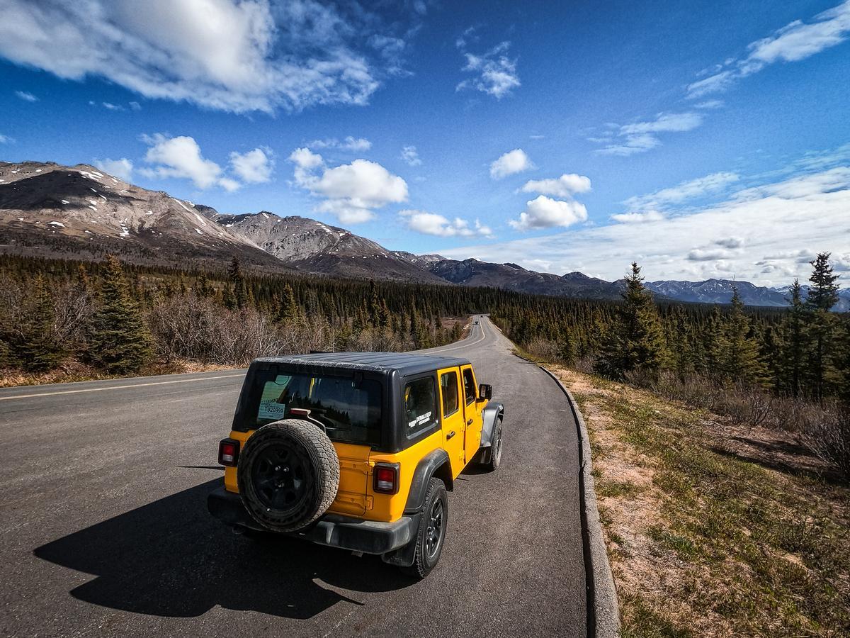 Yellow Jeep Wrangler on scenic Denali road, Alaska - Best jeep tours and reviews