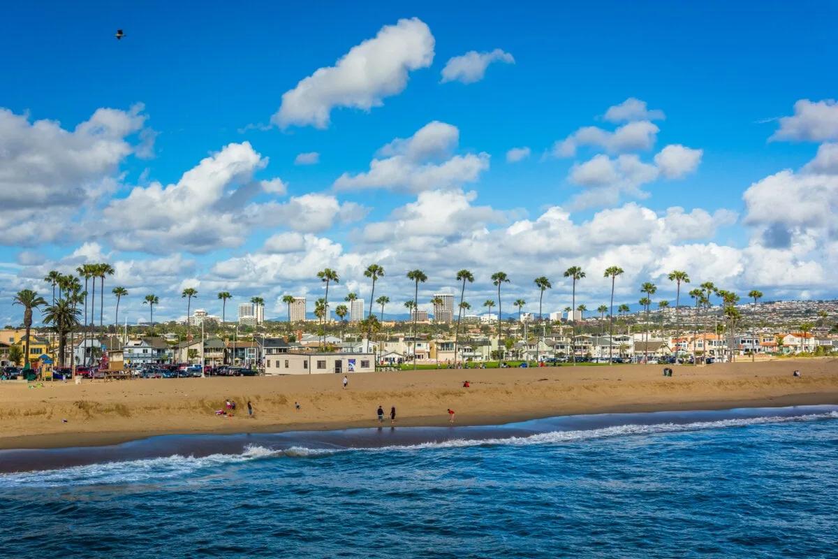 Waves in the Pacific Ocean and view of the beach from Balboa Pier in Newport Beach, California