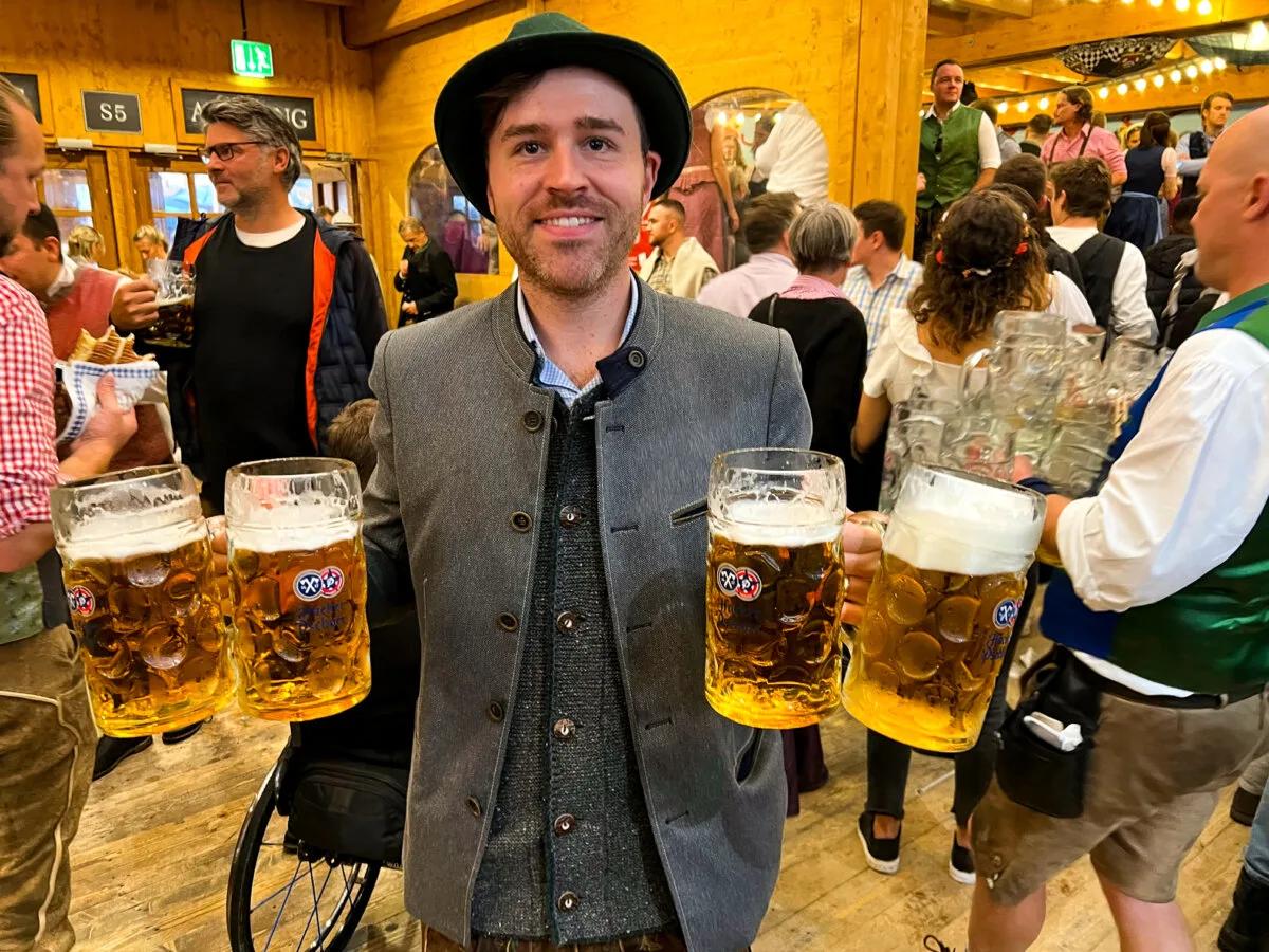 Kyle Kroeger, ViaTravelers author, holding 1 Liter Beers During Oktoberfest