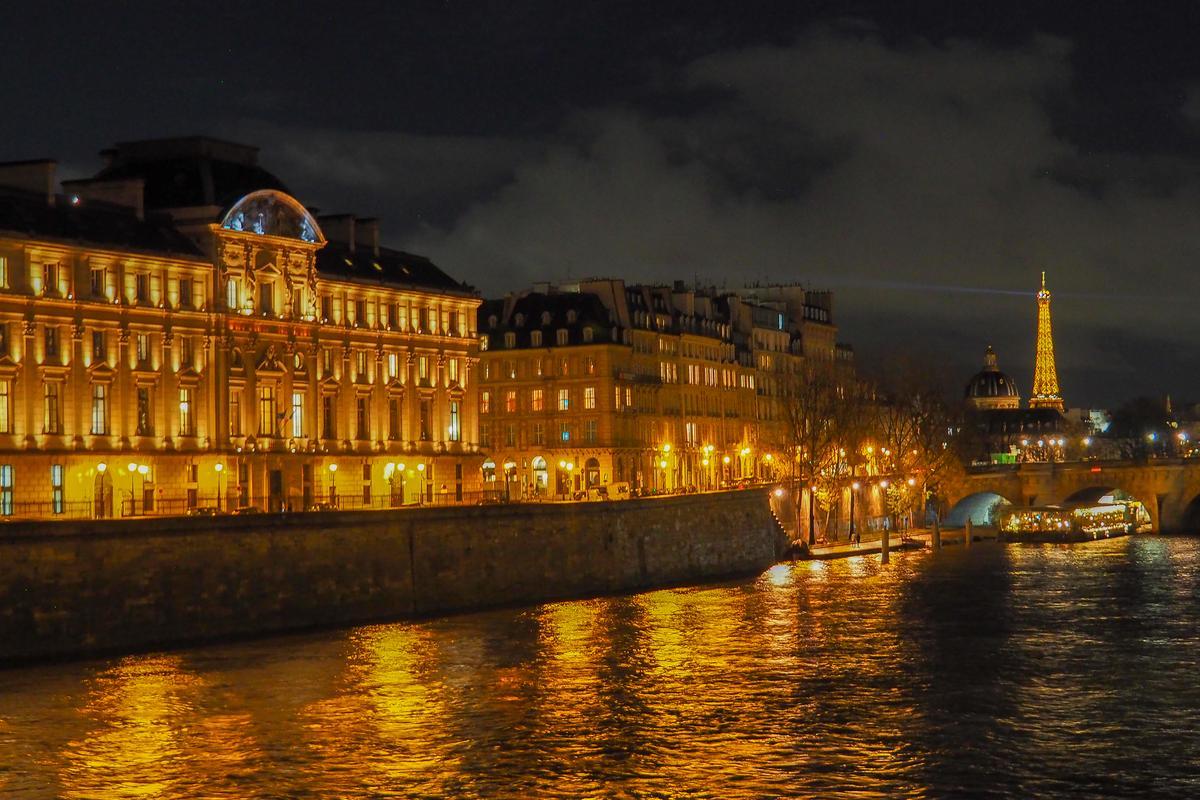 Eiffel Tower and Seine River at night with city lights in Paris