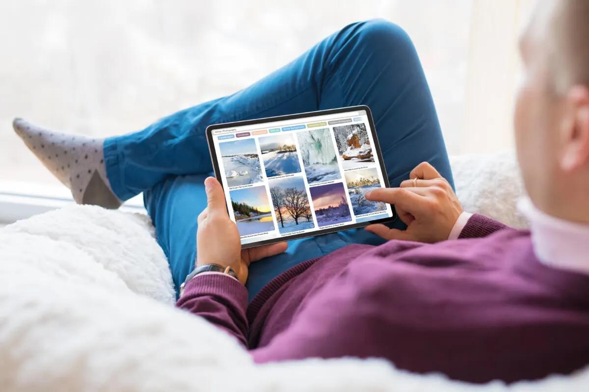 Man looking at Pinterest winter travel spot photos