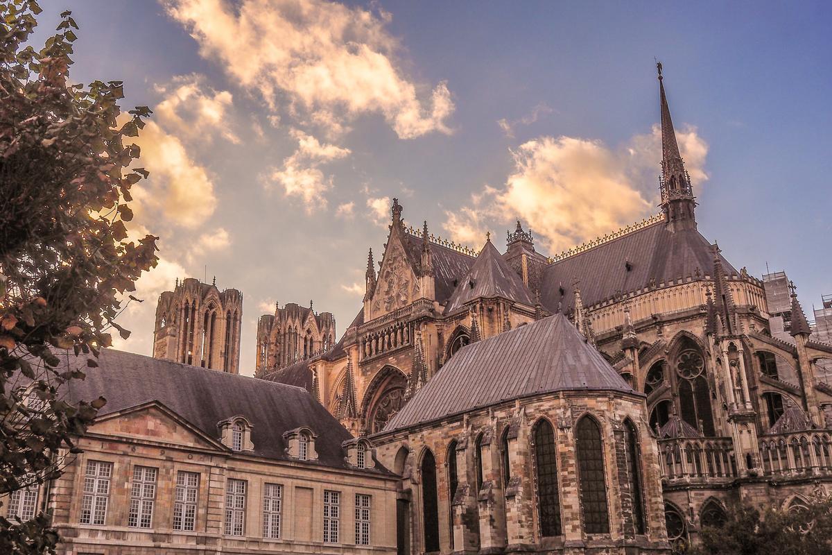 Sunset over Reims Cathedral showcasing its Gothic architecture