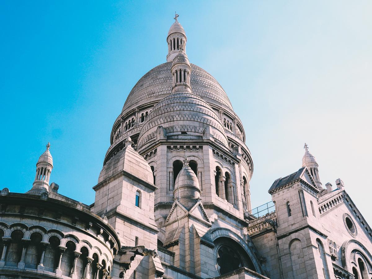 Sacré-Cœur Basilica in Montmartre, Paris against a blue sky