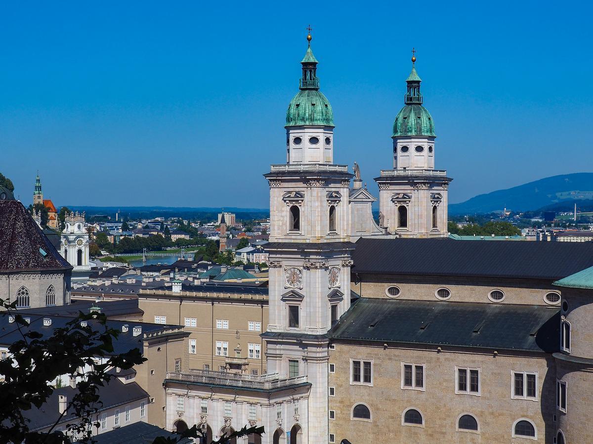 Salzburg Cathedral Baroque architecture and green domes against blue sky