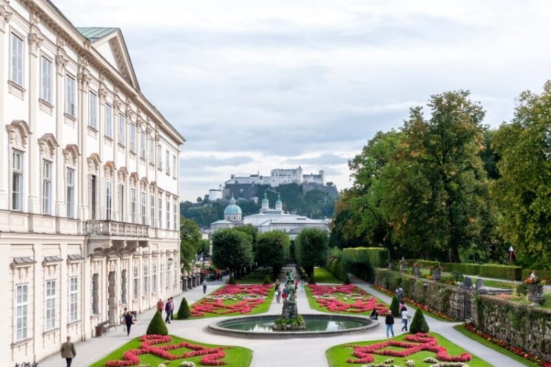 White Colored Mansion and Garden with a Statue