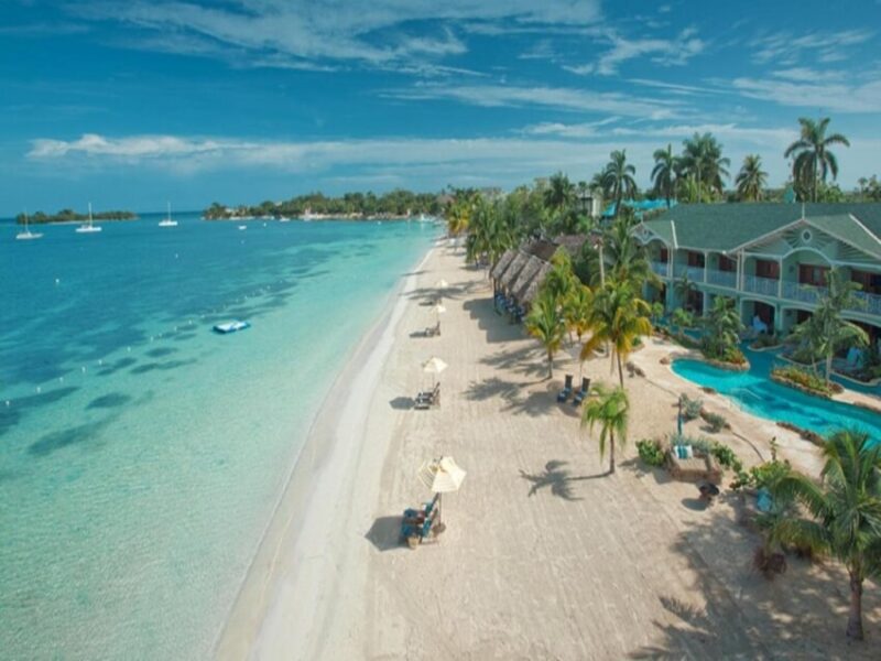 Seven Mile Beach in Negril with turquoise water and a resort pier
