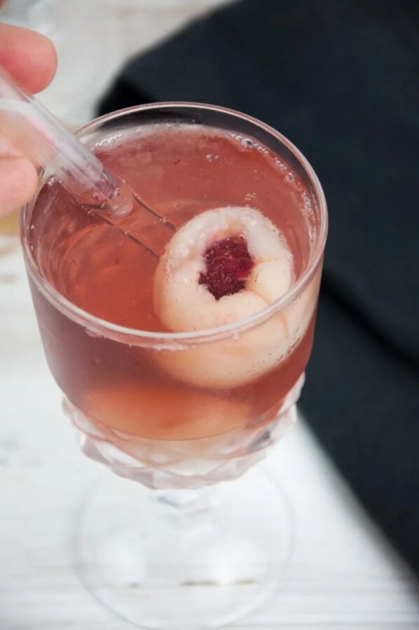 A bizarre cocktail featuring an animal eyeball submerged in a drink.