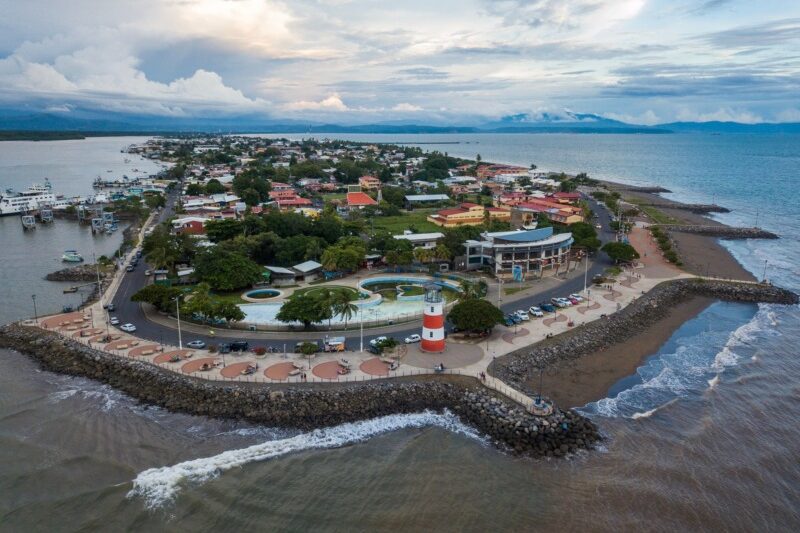 Alt text for the image could be "Aerial view of luxurious resort on small island surrounded by crystal-clear waters and lush greenery in Costa Rica."