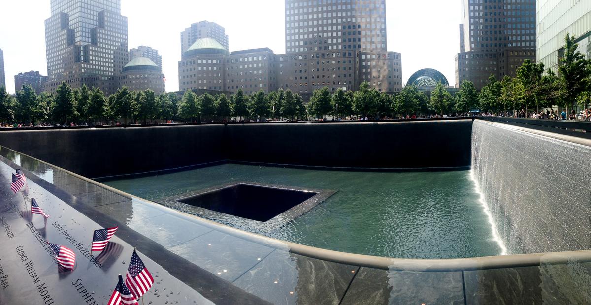 9/11 Memorial panoramic view with flags and cascading waterfalls