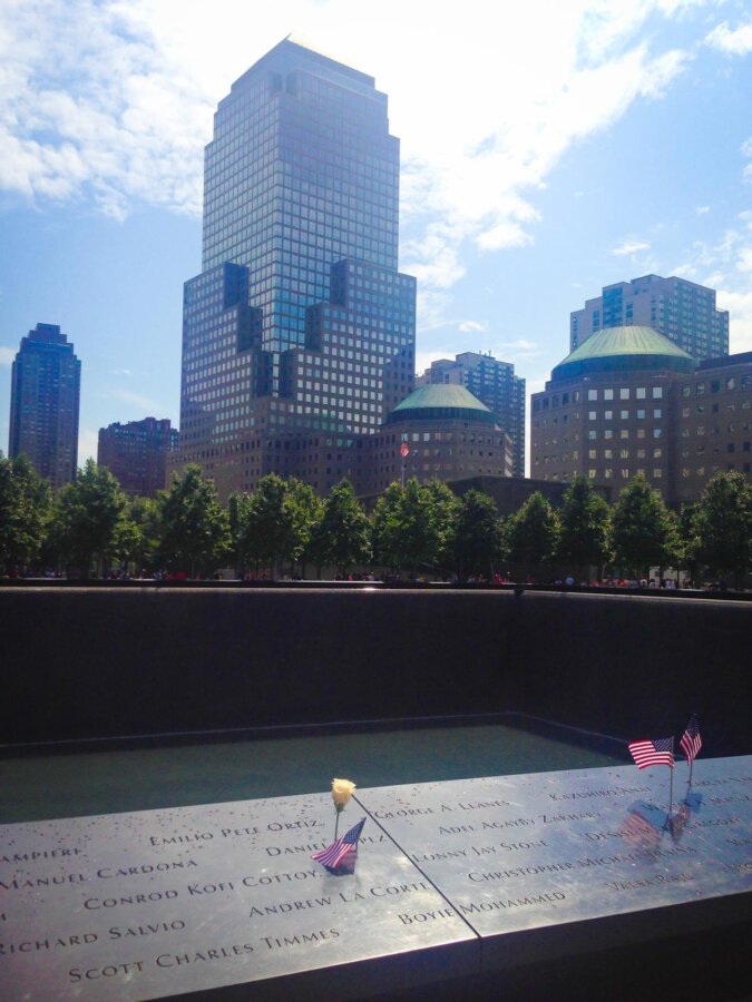 9/11 Memorial North Pool with names and flags in NYC