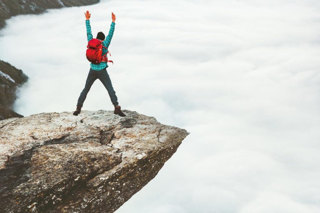 Adventurous Tourist at Trolltunga Cliff Norway