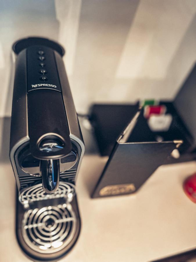 "Modern coffee machine on white countertop at Alfons Boutique Hotel"