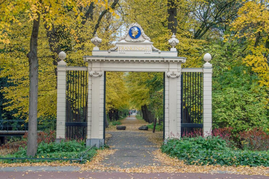 Historic entrance gate to Park Frankendael surrounded by autumn foliage