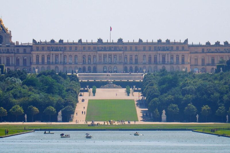 Château de Versailles gardens, grand palace view, lush greenery, boating, iconic French landmark
