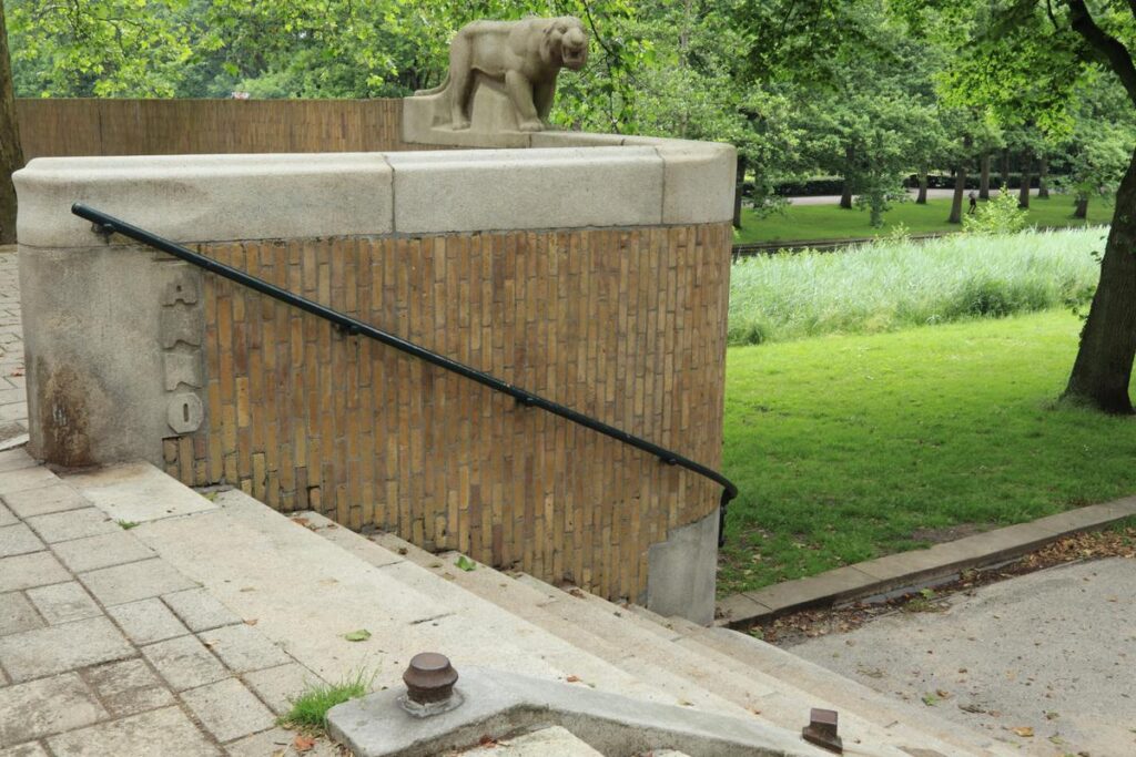 Brick entrance and lion sculpture at Erasmuspark in Amsterdam-West