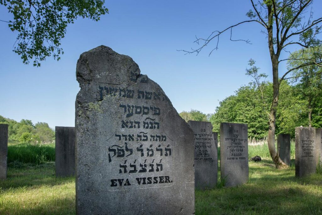 Jewish cemetery in Flevopark, Amsterdam with weathered tombstones and Hebrew inscriptions