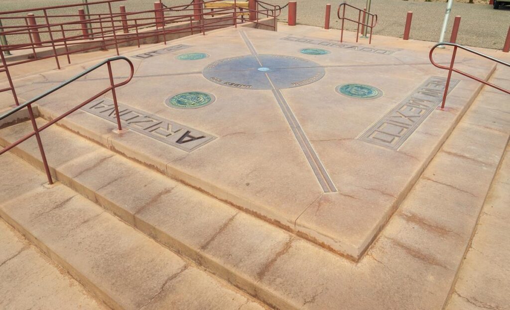 Four Corners Monument marker with boundary lines for Arizona, Utah, Colorado, and New Mexico