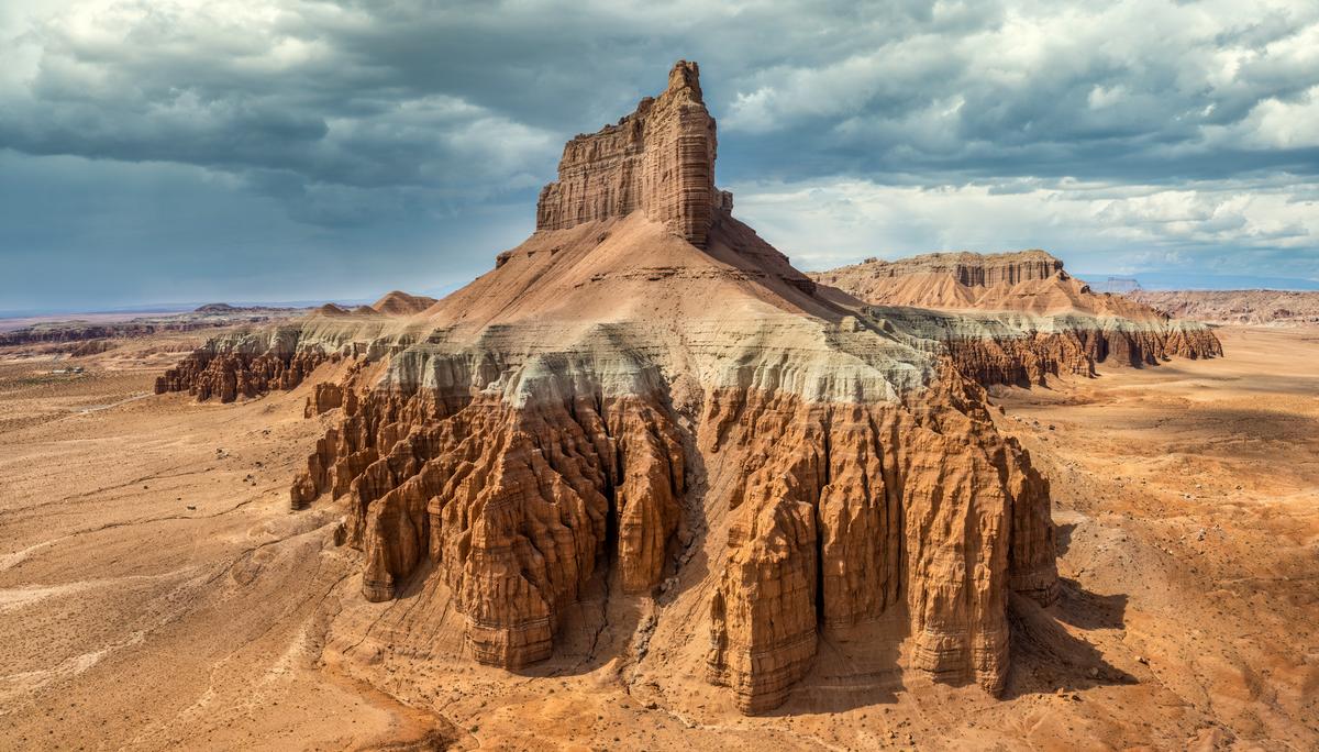 Sandstone goblins and cliffs across Goblin Valley State Park under a partly cloudy sky