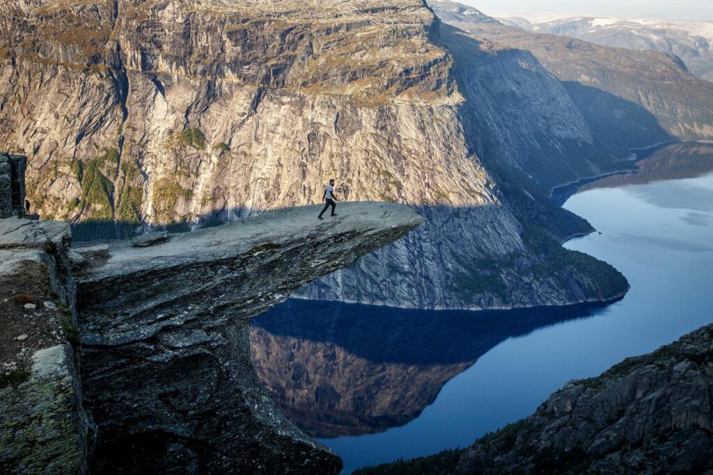 Hiker at Trolltunga Cliffside Norway