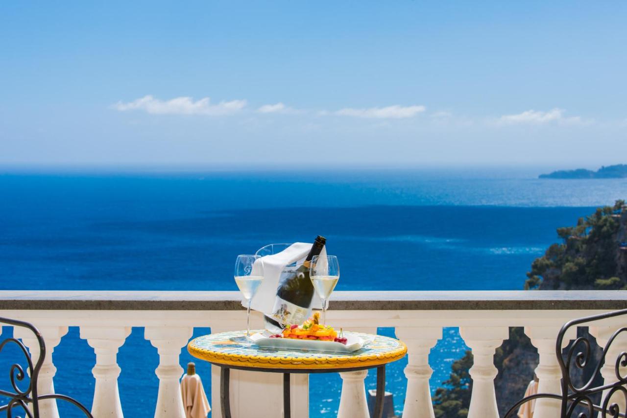Table set with wine, gourmet food, and stunning view at Hotel Villa Gabrisa