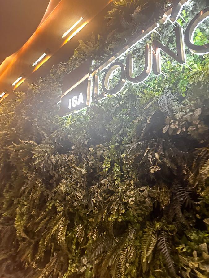 Entrance to IGA Lounge at Istanbul Airport, featuring lush vertical garden decor.