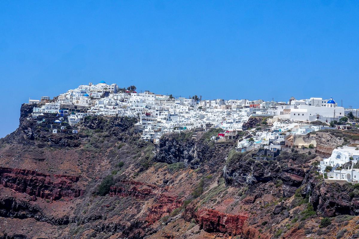 Stunning Santorini sunset view of Imerovigli's white-washed architecture and Aegean Sea