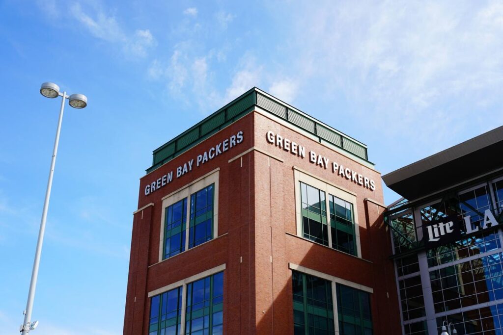 Lambeau Field Atrium entrance on a sunny day with clear blue sky.