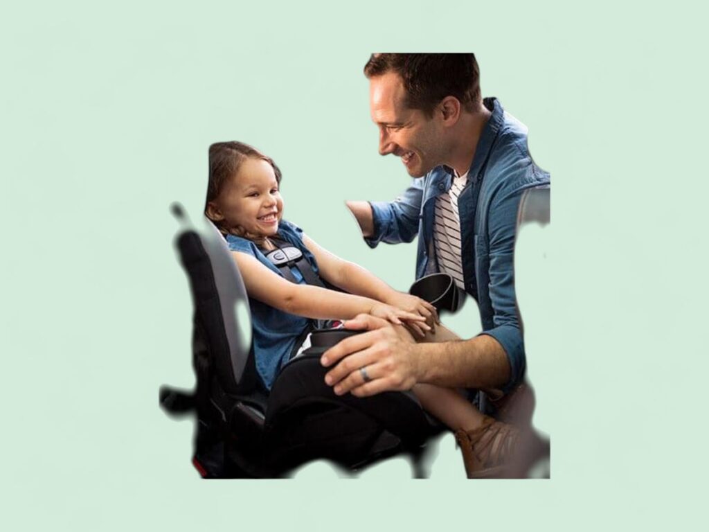 Man securing young girl in a car seat