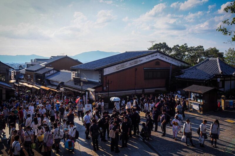 Bustling Matsubara-dori, gateway to Kiyomizu-dera Temple, packed with tourists and traditional architecture.