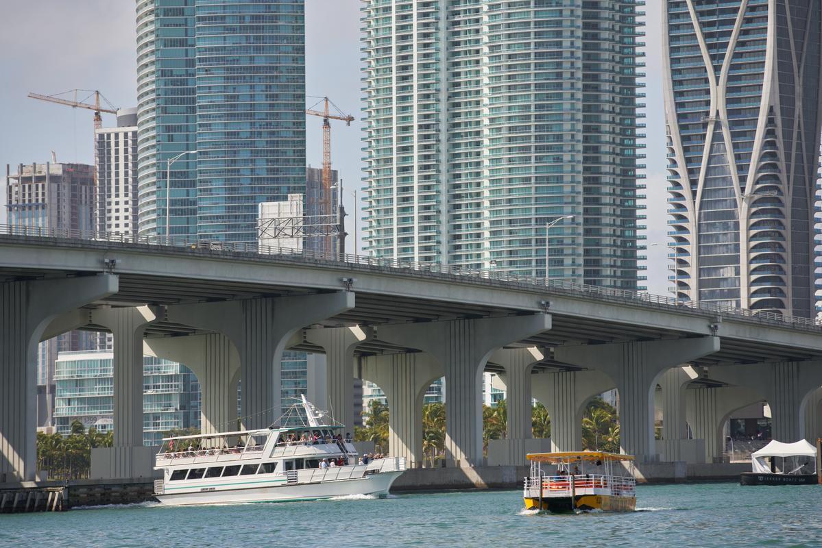 Water Taxi cruising along Biscayne Bay with Downtown Miami skyline view.