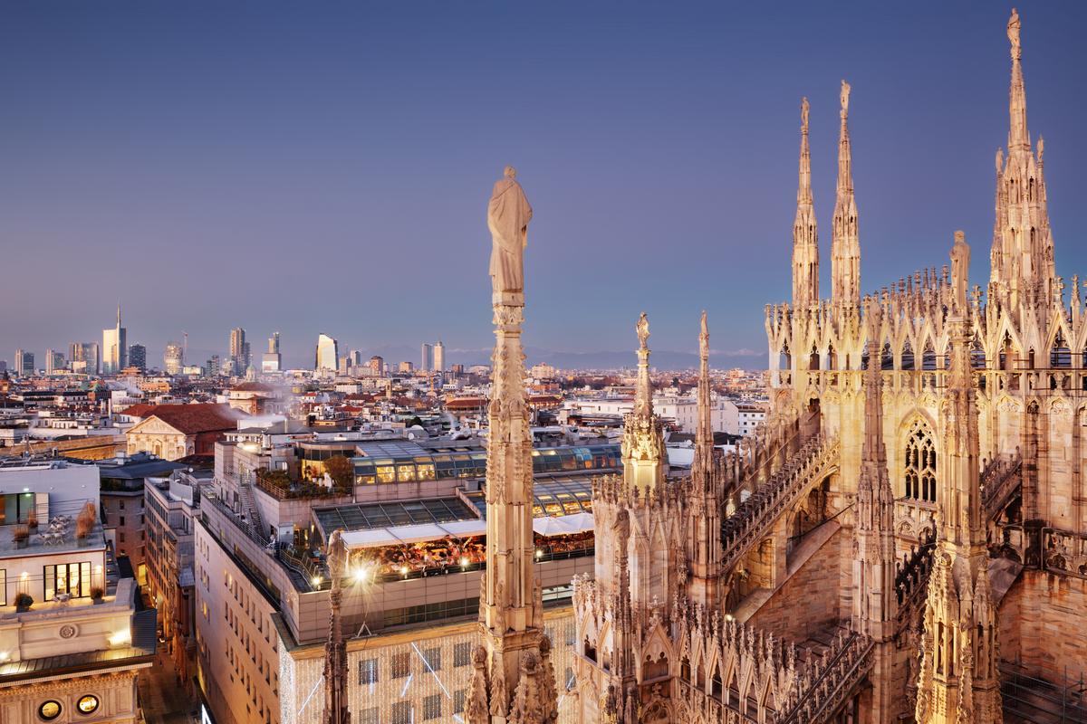Twilight view of Milan skyline with Duomo gothic spires, Italy