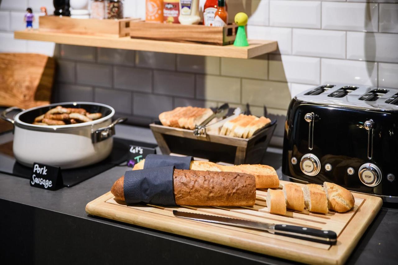 Alt Text 1 "Freshly Baked Bread and Sleek Toaster on Clean White Kitchen Counter (Moxy-Paris-Bastille-3)" Alt Text 2 "Minimalist White Marble Kitchen Counter with Rustic Bread and Vintage Toaster (Moxy-Paris-Bastille-3)" Alt Text 3 "Cozy Wooden Kitchen Counter with Soft White Bread and Classic Toaster (Moxy-Paris-Bastille-3)"