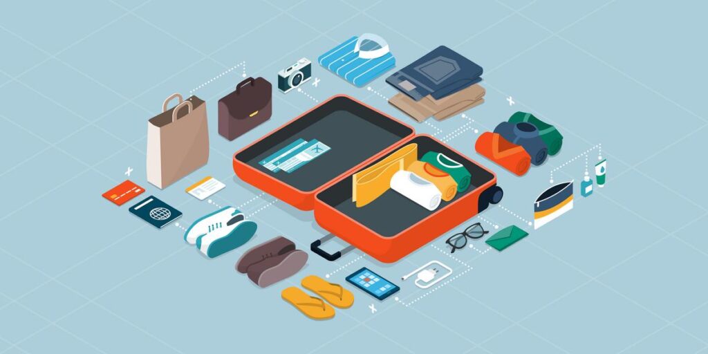 Efficiently packed suitcase with neatly organized travel items on soft blue background.