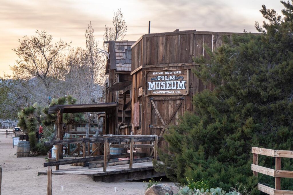 Vintage wooden facade of Ernie Kester's Film Museum in Pioneertown, California, showcasing rustic Wild West charm against a desert backdrop.