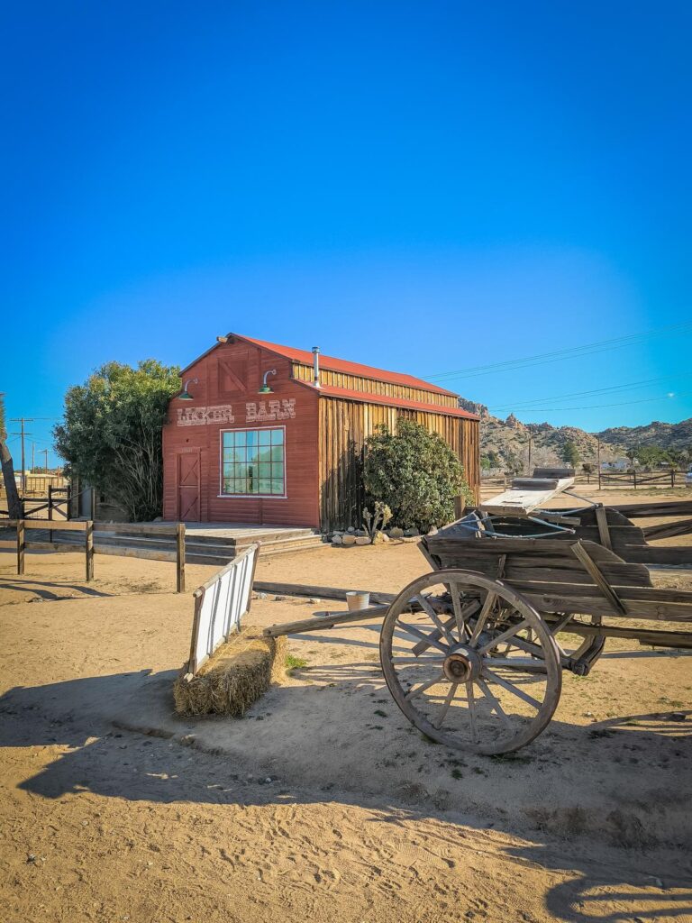 Sunny view of historic Wild West facade with a wooden wagon in Pioneertown, CA