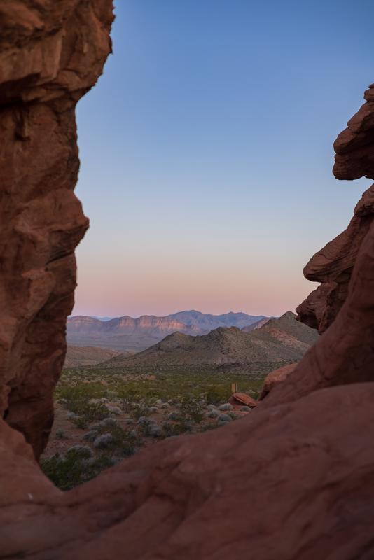 Sunrise at Redstone Trail, serene desert landscape framed by red rock formations under soft dawn light.