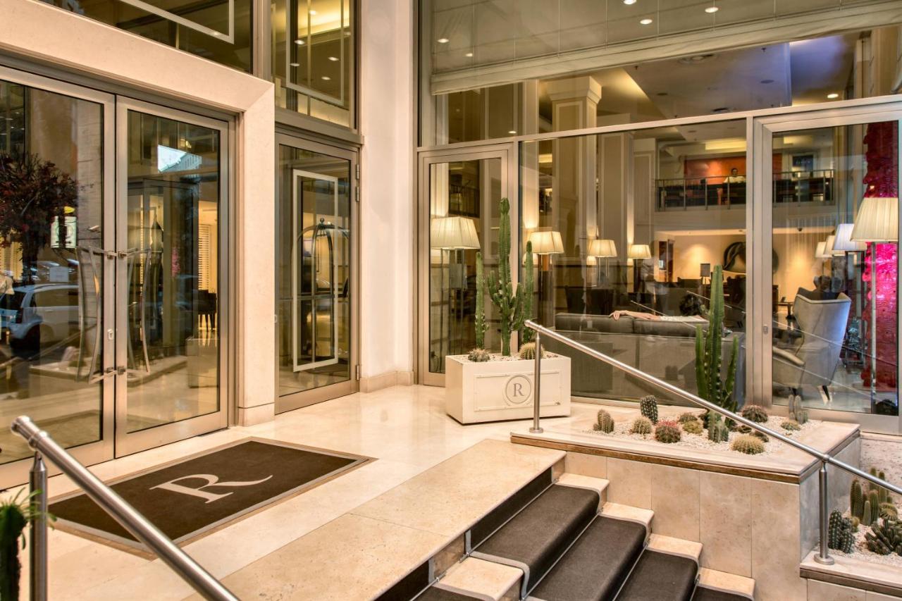 Grand hotel lobby with high ceilings, elegant decor, and bustling activity at Renaissance Naples Hotel
